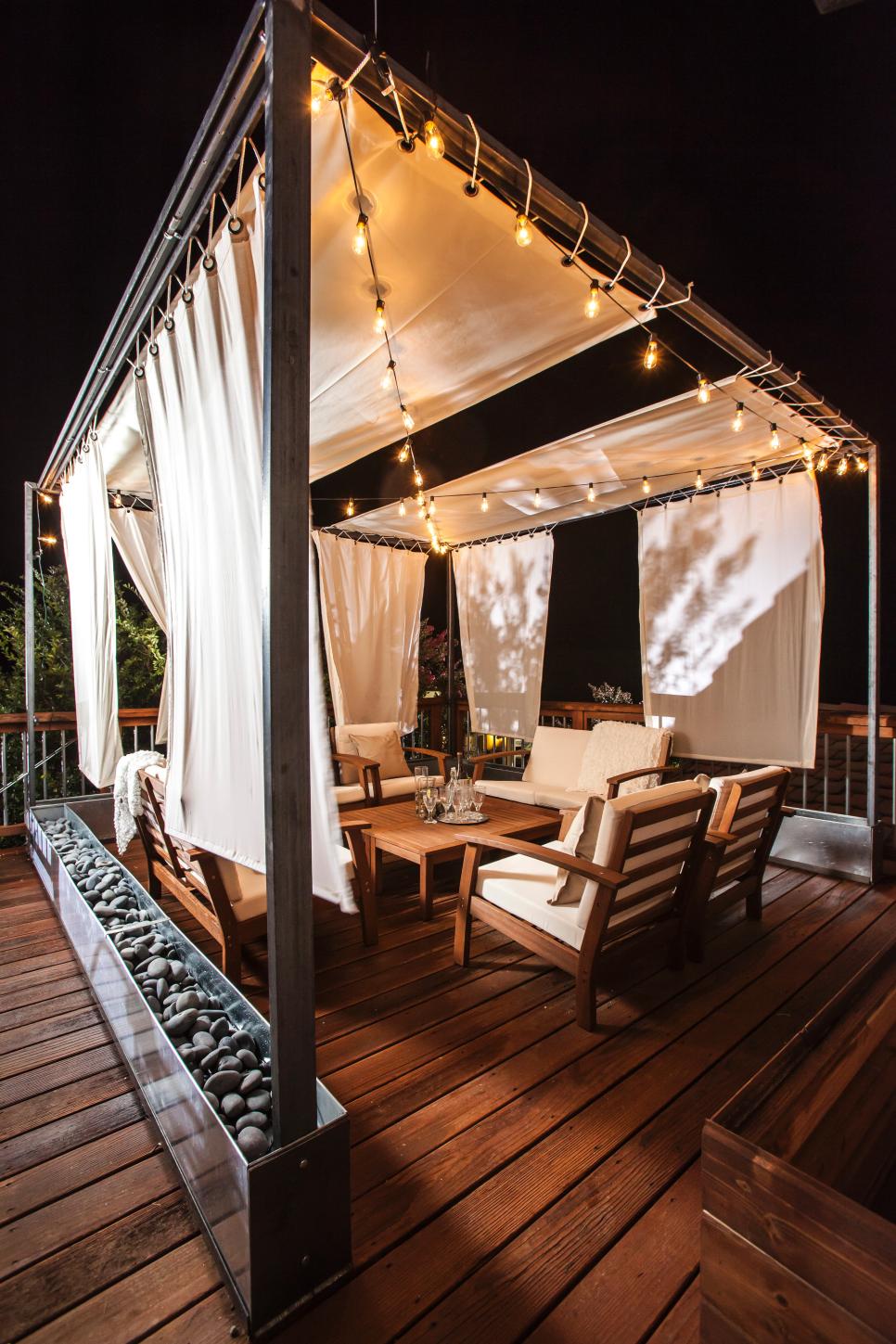 To turn an upstairs deck into a gorgeous retreat add some seating, string lights and rain curtains there.