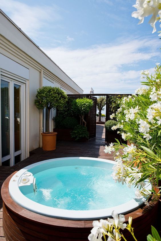 a built-in jacuzzi with a view of the private garden is a peaceful and light-filled space that looks nice