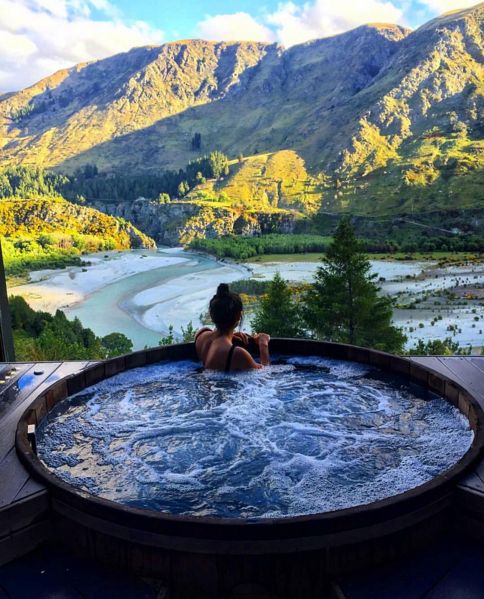 A built in jacuzzi with a wooden deck around and a jaw dropping view of the mountains and lakes is a fantastic space to relax in