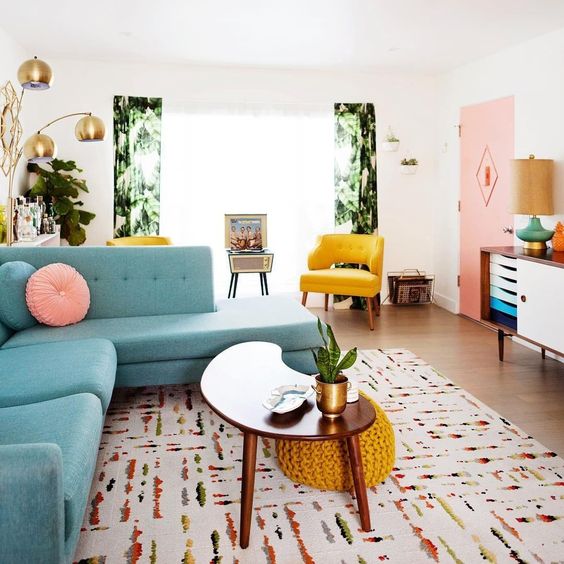 a colorful living room with pink, yellow, blue, green and lots of prints and textures plus metallic touches