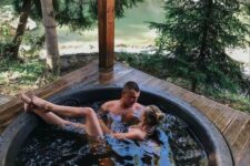 a jacuzzi built into a deck, with a gorgeous forest view is a lovely idea to relax together and spend quality time