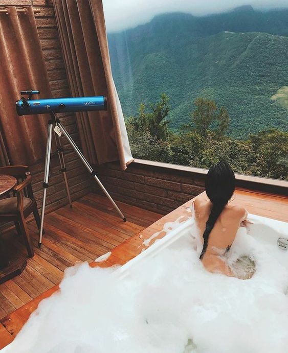 a jacuzzi inside with a panoramic window that allows watching the mountains and forests is a gorgeous idea to avoid bugs and cold weather