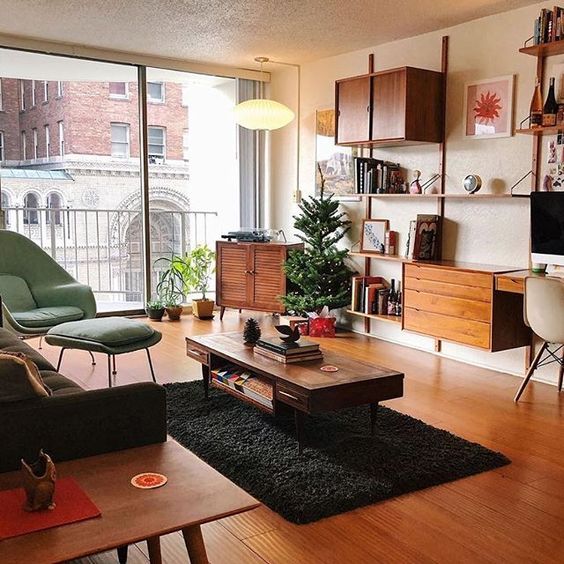 A mid century modern space with elegant furniture, a cool wall unit with closed and open storage, a fluffy rug and a cabinet