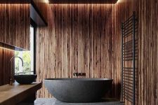 a wooden bathroom design with a moody look