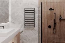 a minimalist bathroom done with light stained wood and white stone tiles, with a wooden vanity and black fixtures