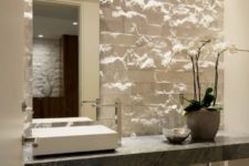 an accent wall done with white decorative stone is a chic idea for a contemporary space