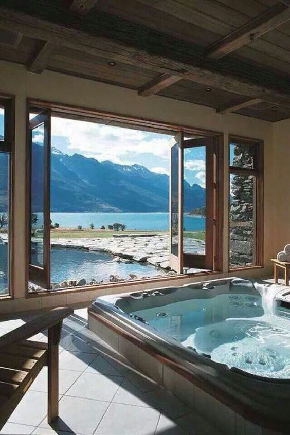 an indoor-outdoor jacuzzi with a breathtaking mountain and mountain lake view just wows and feels like heaven