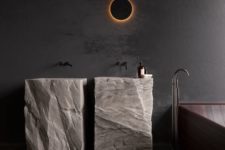 two free-standing sinks cut out of rough stone looks extremely spectacular and super bold