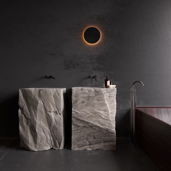 Two free standing sinks cut out of rough stone looks extremely spectacular and super bold