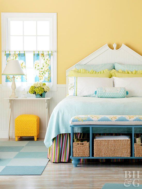 a blue bedding set, a sunny yellow stool, some lemon pillows and floral curtains for a vintage spring bedroom