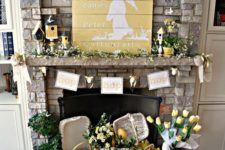 a bright and welcoming spring mantel with lots of yellow blooms, bird houses, lemons, a bunny sign and much more
