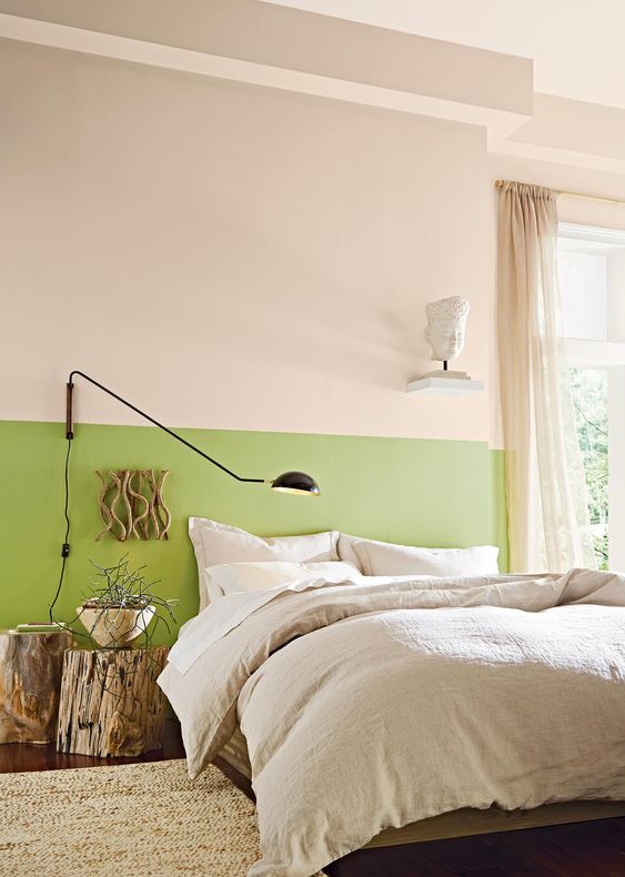 a bright green touch on the wall, tree stumps as side tables and a branch artwork for a fresh spring feel in a modern way