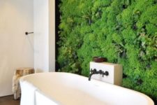 a contemporary bathroom in neutrals with a living wall that takes over the whole space at once