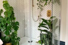 a contemporary bathroom with potted plants on the floor and suspended in the shower space