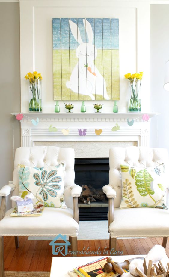 a fun Easter mantel with yellow rose arrangements, a colorful bunny artwork, a bird garland and bottles