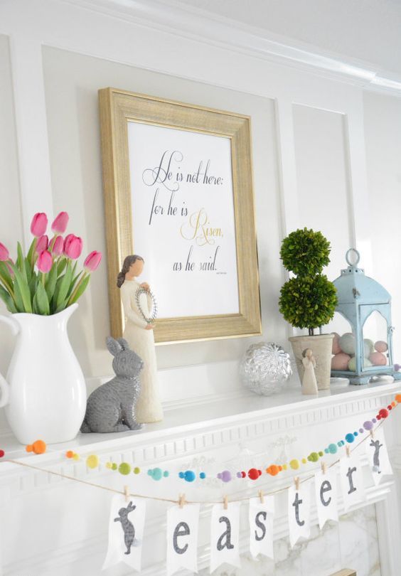 a pastel Easter mantel with a tulip arrangement, a blue lantern with faux eggs, topiaries and a bead garland and bunting