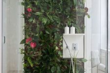 a shower space with a statement living wall that adds a vivacious and fresh feel to the space