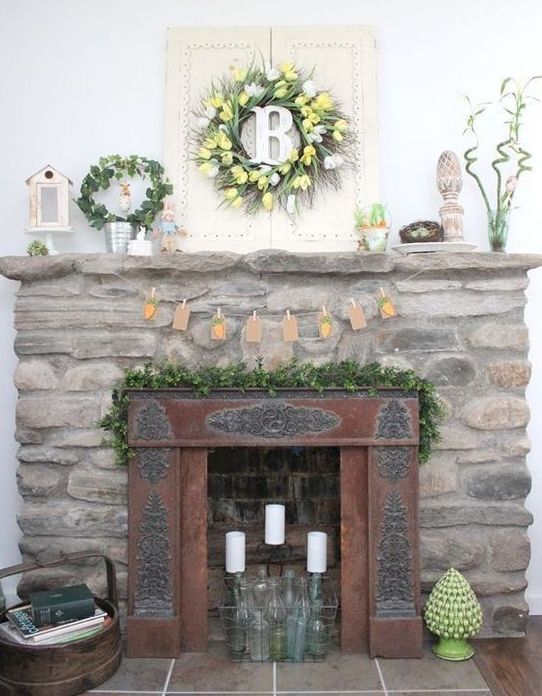 a vintage Easter mantel with a tulip wreath, a greenery wreath, a carrot bunting and some faux eggs