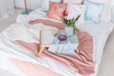 blue, pink and floral bedding is a simple and easy idea to bring a spring feel to the space without wasting much money
