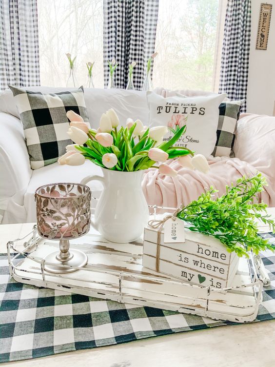 refresh your monochromatic living room with pink blooms, greenery and pink linens and make it feel like spring