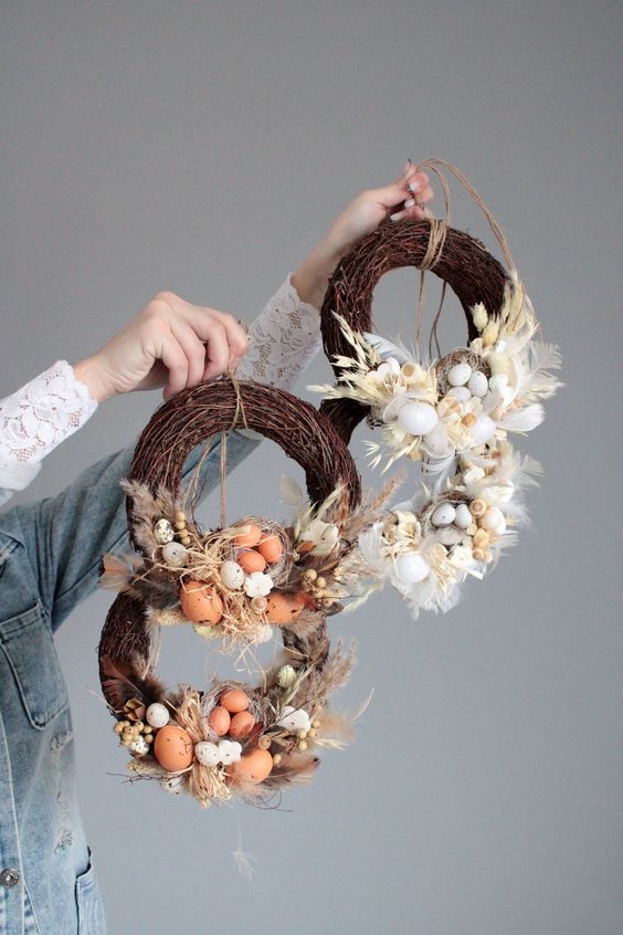 rustic Easter wreaths of vine, eggs, feathers, grasses and a nest are great for outdoor Easter decor