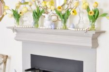 simple Easter mantel styling with yellow tulips, wooden ebads and fake blue eggs and a bunny