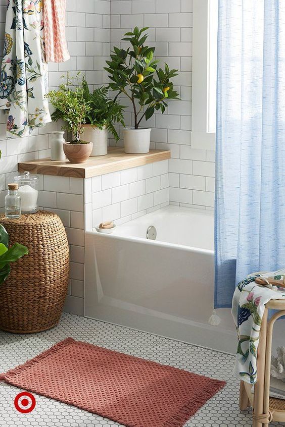 some potted greenery and a little lemon tree to accent the neutral bathroom and wicker and wood for a warm touch