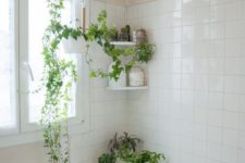 some wall shelves and suspended planters with greenery make the neutral bathroom feel and look very fresh