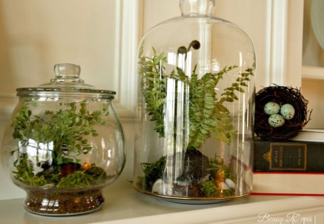 Vintage inspired spring mantel with greenery terrariums and a fake nest with eggs