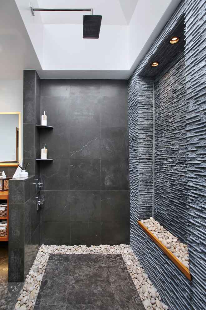 To make a dark shower a bit more cozy add some pebbles  to its drain system.