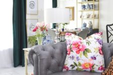 a bright floral print pillow and fresh blooms in a vase make the home office feel fresh and airy