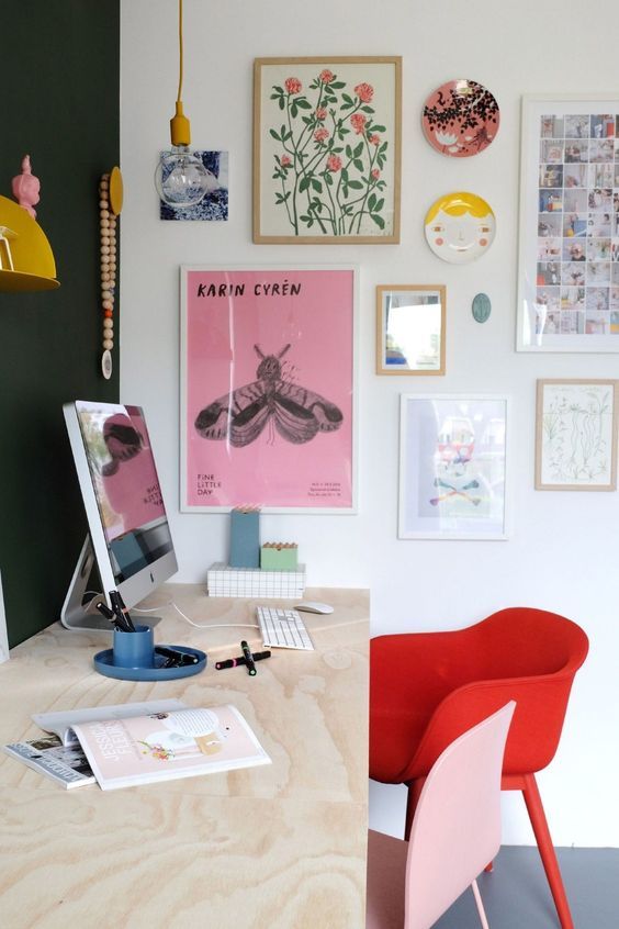 A bright gallery wall and colorful chairs will make your home office more inspiring and more spring like