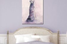 a chic feminine bedroom in lilac and neitrals, with lilac walls, neutral refined furniture, lilac bedding and an artwork plus a crystal chandelier