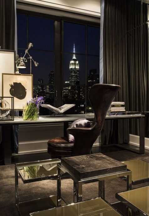a luxurious home office with a large desk, a leather chair, a stone stool, a gorgeous view and glass side tables