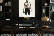 a modenr moody masculine home office with blakc built-in shelves, a dark stained desk, a sport-themed artwork plus shiny metal accents