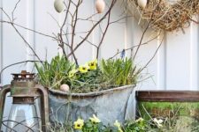 chic front Porch Easter decor with an Easter egg tree, potted blooms and a vintage lantern