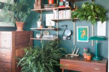 lots of potted greenery and a green wall make the home office bright, fresh and spring-like