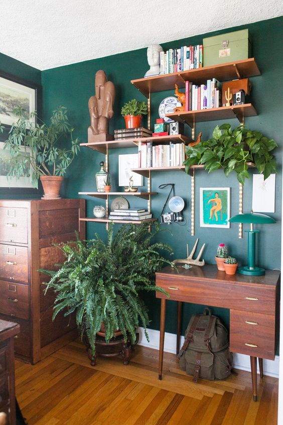 Lots of potted greenery and a green wall make the home office bright, fresh and spring like