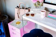 a bright and fun girlish home office with a navy stool, a hot pink cabinet, a bright printed rug and more pink touches