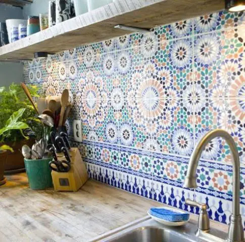 a colorful and patterned tile backsplash done in green, rust and navy is a lovely idea for a modern and neutral space