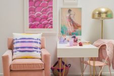 a colorful feminine space with a bright gallery wall, blush chairs and a rug and touches of gold for more chic