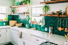 a neutral modern kitchen with black handles, with a bold emerald brick backsplash and open shelves is a very cool and chic idea