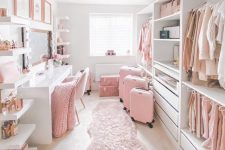a very girlish closed with open storage units and drawers, with open selves, a white vanity with a large mirror and pink touches