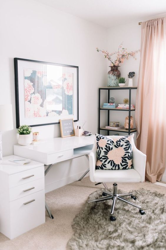 an ethereal home office with blush curtains, a floral artwork, a floral pillow and white furniture