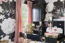 an exquisite feminine home office with floral walls, a black and gold desk, pink curtains and a gold burst chandeliers
