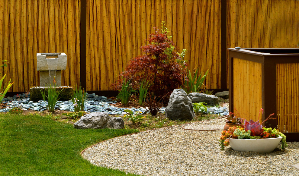 A bamboo screen is a perfect backdrop for your garden. Adding a water feature like a small waterfall is also a great idea because water gives positive energy to the space.