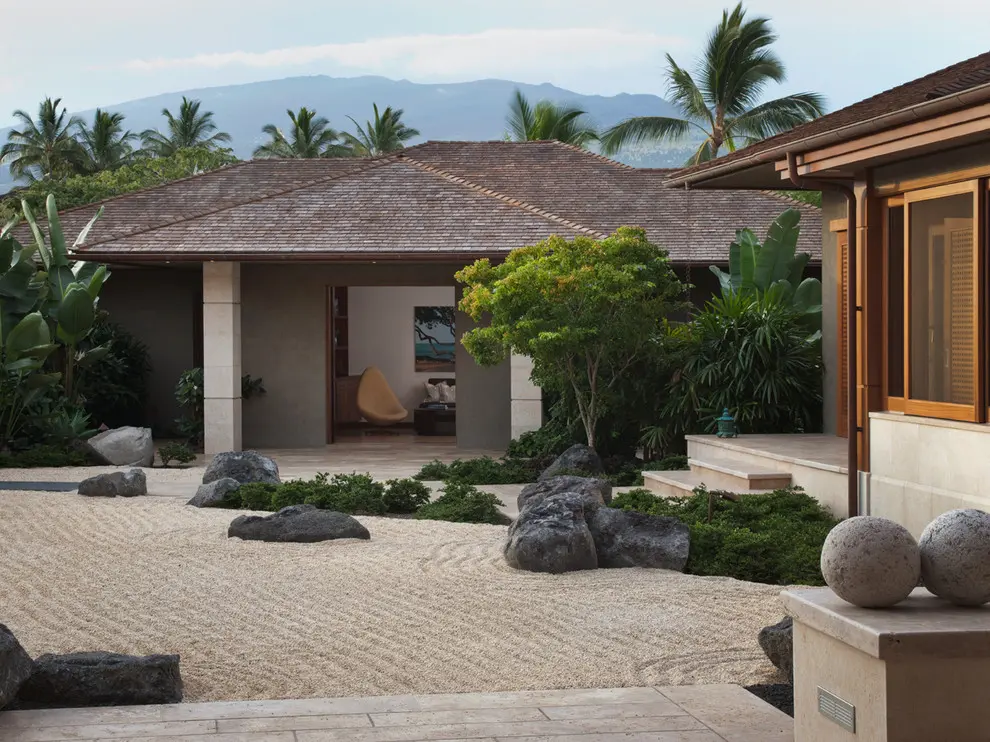 A Japanese-inspired front yard is also a great idea. A crushed stone of the right color would make your house blend with the landscape better.