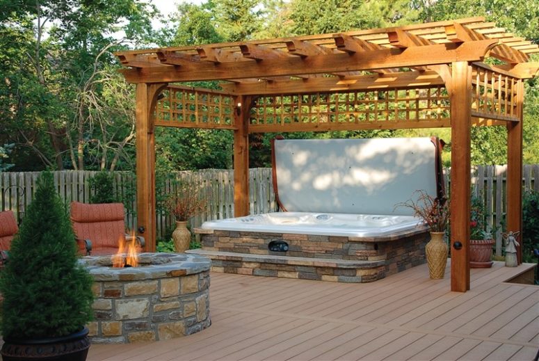 A hot spring spa surrounded covered natural stone is a beautiful addition to your outdoor space. (Hot Spring Spas)
