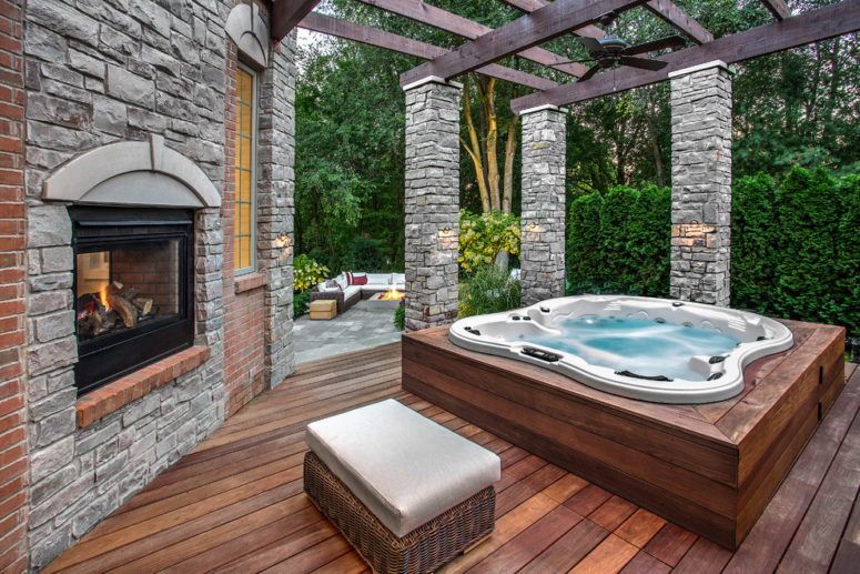 A fireplace and a spa bathtub is a perfect combination for a cozy patio. (Outdoor Living LLC)