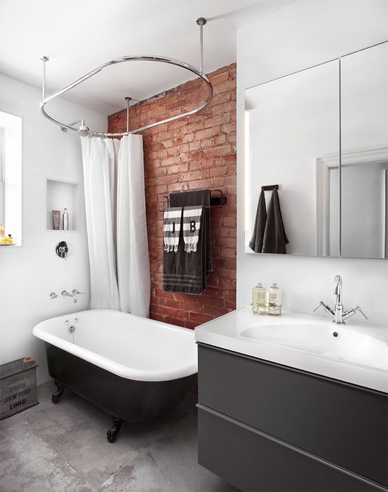 A contemporary bathroom with a red brick touch that makes it more industrial and more eye catchy
